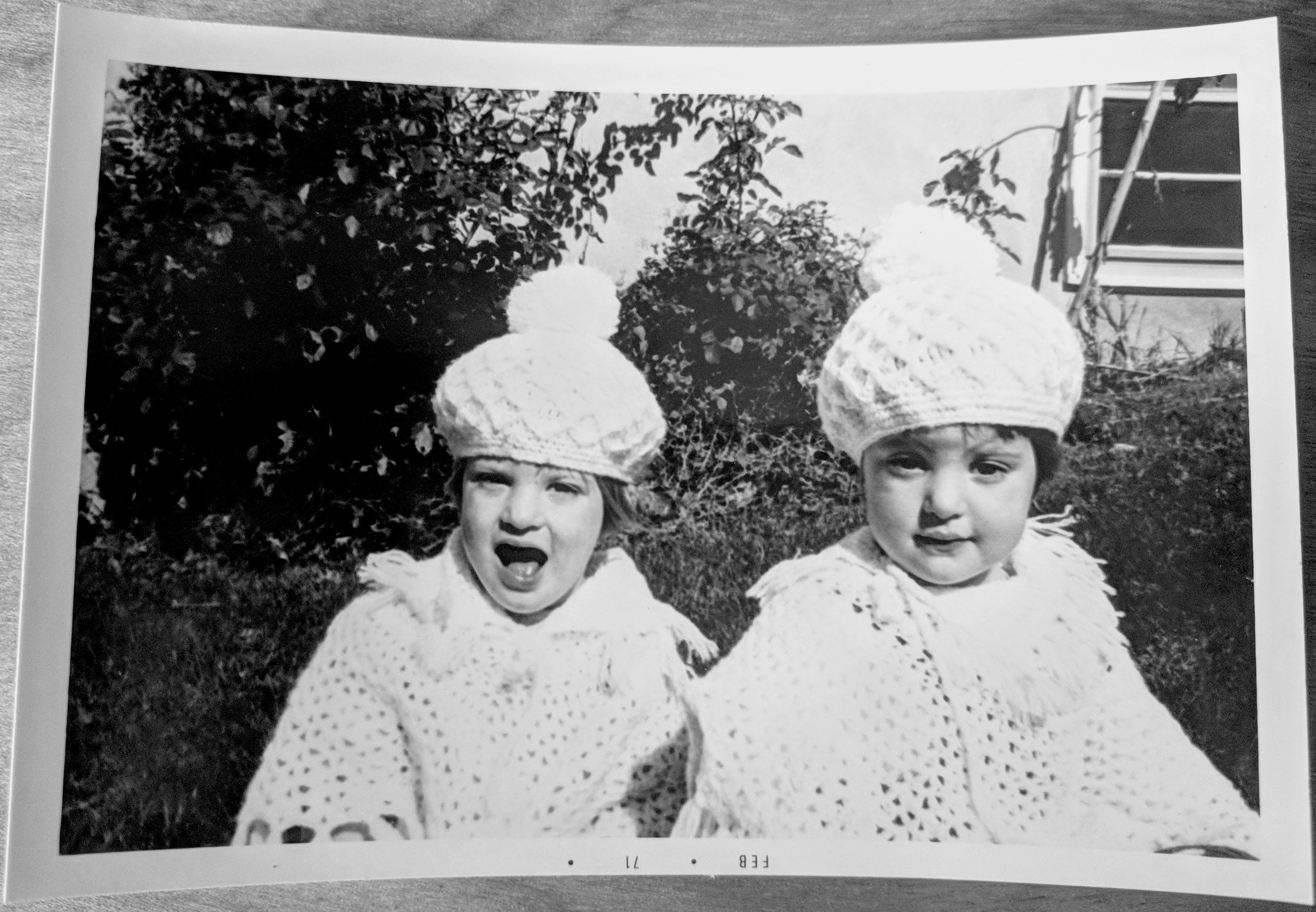 in knitted or crocheted ponchos and hats